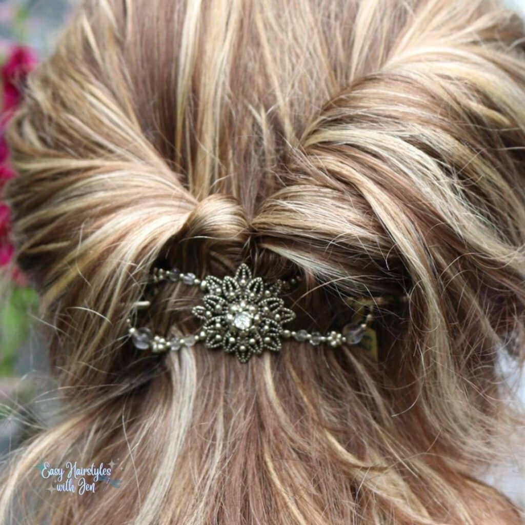 The back of the head of a blond lady with her hair twisted on the sides and coming together being held with a Lilla Rose Flexi Clip.  So is under the post for the 10 dos and don'ts of hair care.