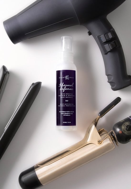 Picture showing Lilla Rose Thermal Defense spray surrounded by a hair dryer, curling iron, and flat iron. This is represented in the article The effects of styling tools on your hair. 